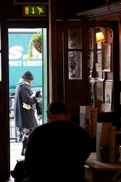 Lady passing cafe door